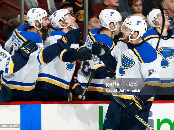 Joel Edmundson of the St. Louis Blues is congratulated by teammates after scoring during their NHL game against the Vancouver Canucks at Rogers Arena...