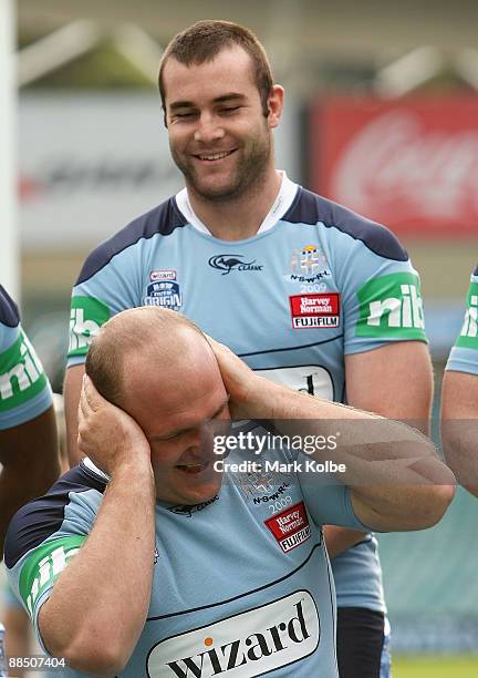 Michael Weyman laughs as he covers his ears from Justin Poore as they wait for the official team photo to be taken during a New South Wales Blues...