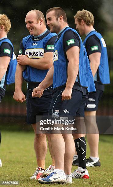 Michael Weyman and Justin Poore share a laugh during a New South Wales Blues State of Origin training session at Sydney Football Stadium on June 16,...