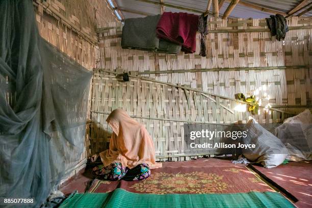 Farmina Begum sits on one side of a wall separating women from men on the day of her wedding to 18 year old Hashimullah, in a Bangladesh refugee camp...