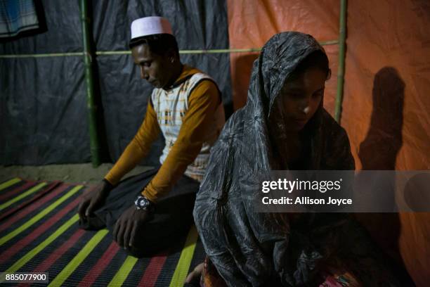 Amina Begum sits with her new husband, 22 year old Munir, after their marriage ceremony in a Bangladesh refugee camp November 25, 2017 in Cox's...