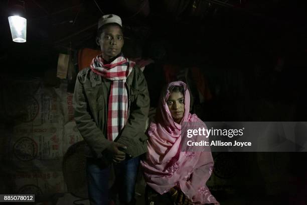 Nur Begum, who doesn't know her age but thinks she is between 14 and 16 years old, poses for photo with her new husband, Rayeed Alam on the day of...