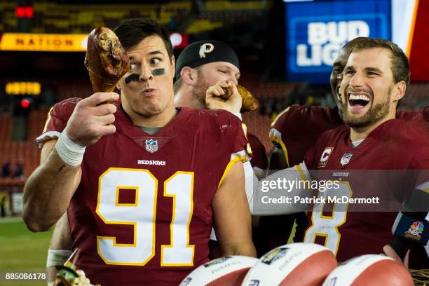 Quarterback Kirk Cousins and outside linebacker Ryan Kerrigan of the Washington Redskins eat turkey after the Redskins defeated the New York Giants...