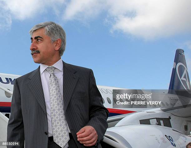 Russian plane maker Sukhoi CEO Mikhail Pogosyan poses in front of the new Sukhoi Superjet 100 jetliner on June 16, 2009 at the week long 48th...
