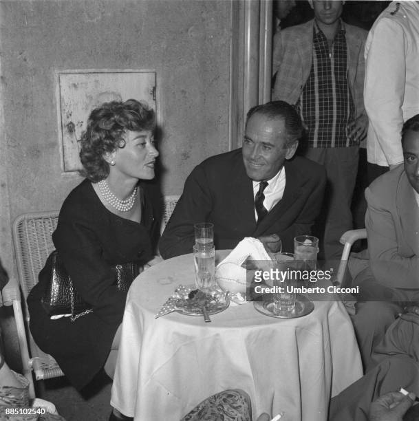 American actor Henry Fonda with Italian baroness Afdera Franchetti at the coffee bar in Via Veneto, Rome 1958.