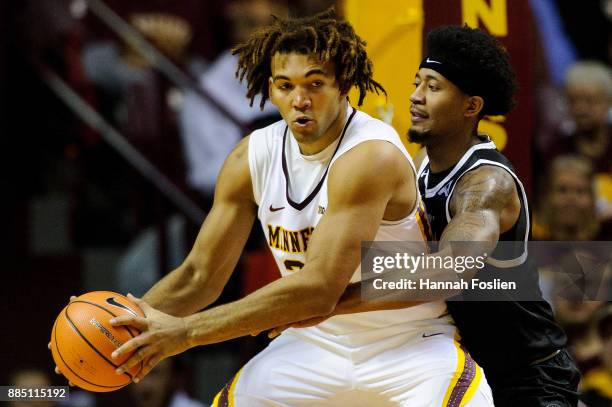 Ramel Thompkins of the USC Upstate Spartans defends against Reggie Lynch of the Minnesota Golden Gophers during the game on November 10, 2017 at...