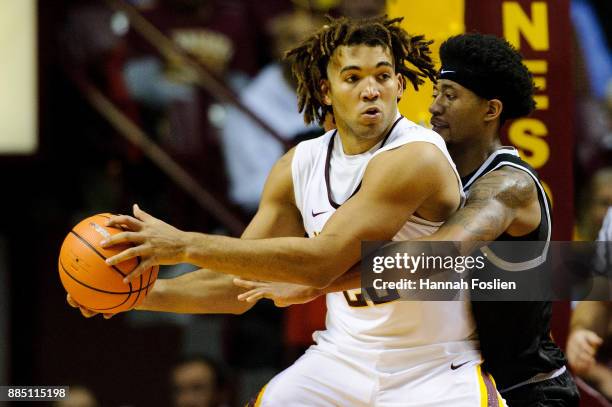 Ramel Thompkins of the USC Upstate Spartans defends against Reggie Lynch of the Minnesota Golden Gophers during the game on November 10, 2017 at...