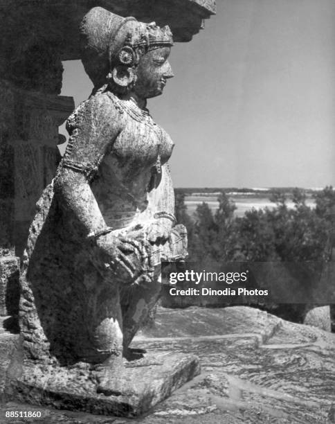 Stone sculpture of a musician at the Sun Temple in Konark, Orissa, India, 1940s.