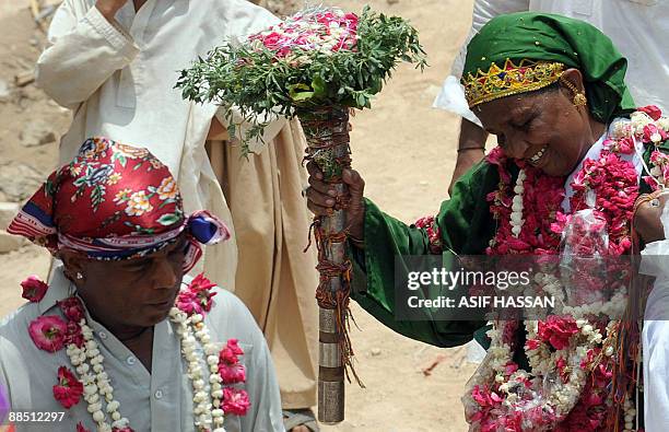 Pakistani devotees dance on the third day of the Sheedi festival at the Manghopir Shrine on the outskirts of Karachi on June 16, 2009. The Sheedi...