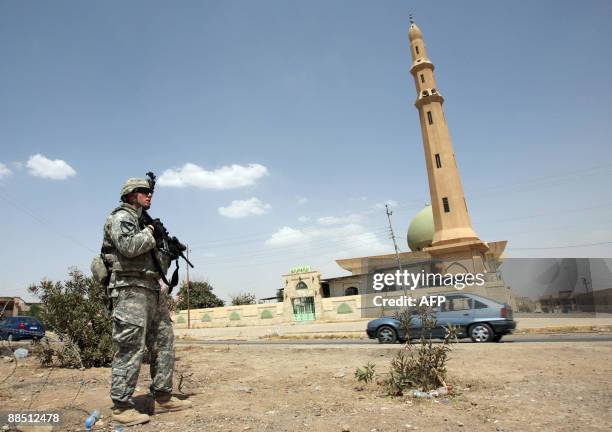Soldier from Bravo battery 2nd battalion 82nd field artillery regiment patrols through the northern Iraqi city of Mosul on June 15, 2009. Most US...