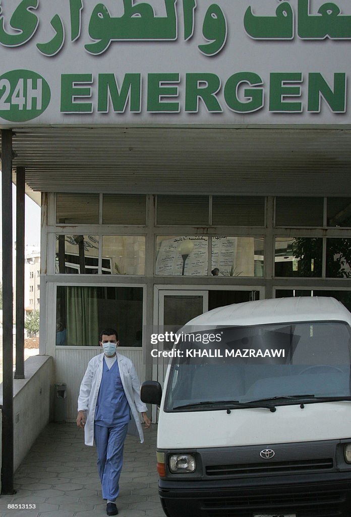 A Jordanian medic wearing a mask walks o