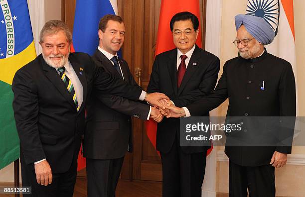 Presidents Luiz Inacio Lula da Silva of Brazil, Dmitry Medvedev of Russia, Hu Jintao of China, and Indian Prime Minister Manmohan Singh shake hands...
