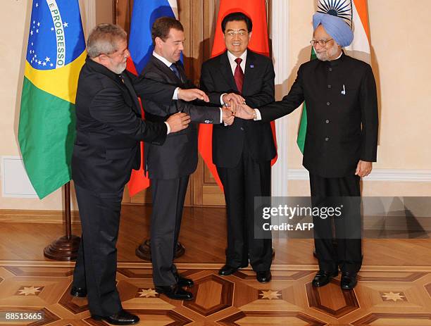 Presidents Luiz Inacio Lula da Silva of Brazil, Dmitry Medvedev of Russia, Hu Jintao of China, and Indian Prime Minister Manmohan Singh shake hands...