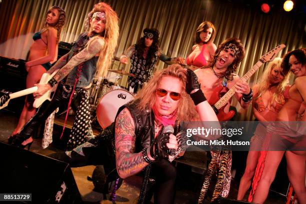 Lexxi Foxxx, Stix Zadinia, Michael Starr and Satchel of Steel Panther pose on stage with models at the Canal Room on April 1st, 2009 in New York.