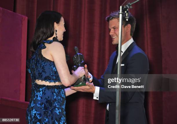 Christina Bennington accepts the Evening Standard Radio 2 Audience Award for Best Musical from Jeremy Irvine at the London Evening Standard Theatre...