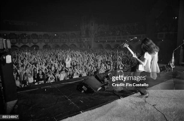 Bass player Geddy Lee of Rush performs on stage during the All The World's A Stage tour of the US in May 1977.