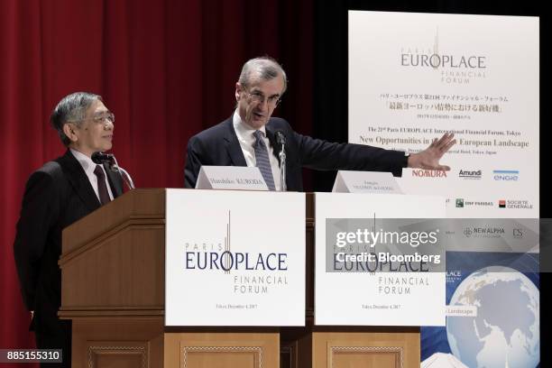 Francois Villeroy de Galhau, governor of the Bank of France, right, speaks while Haruhiko Kuroda, governor of the Bank of Japan , looks on at the...