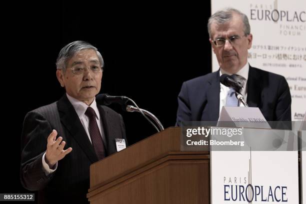 Haruhiko Kuroda, governor of the Bank of Japan , left, speaks while Francois Villeroy de Galhau, governor of the Bank of France, looks on at the...