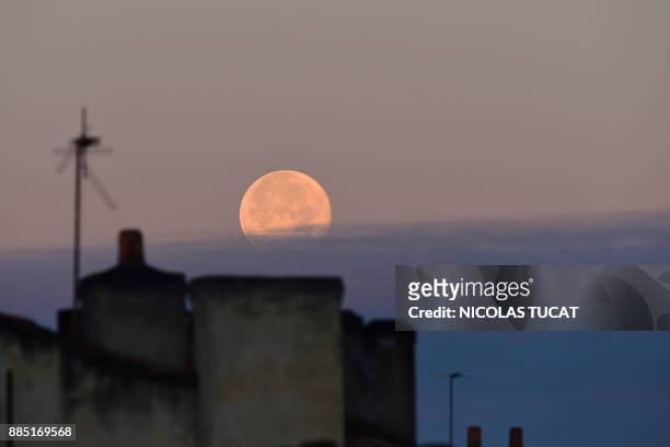 The supermoon is seen above Bordeaux, southwestern France, on December 4, 2017. A supermoon is a full moon or a new moon that approximately coincides...