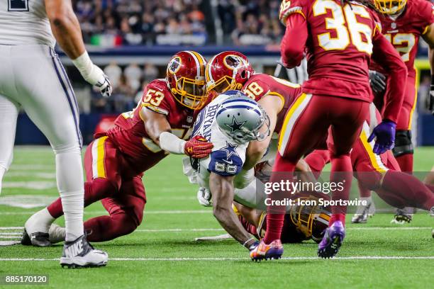 Dallas Cowboys wide receiver Dez Bryant gets tackled by Washington Redskins cornerback Kendall Fuller , linebacker Zach Brown and defensive tackle...