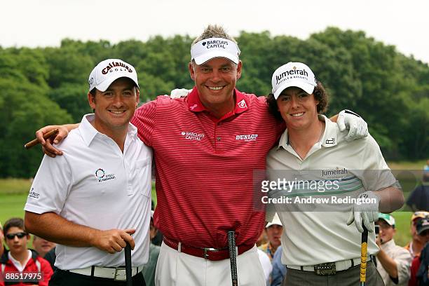 Graeme McDowell, Darren Clarke and Rory McIlroy of Northern Ireland pose together during the second day of previews to the 109th U.S. Open on the...