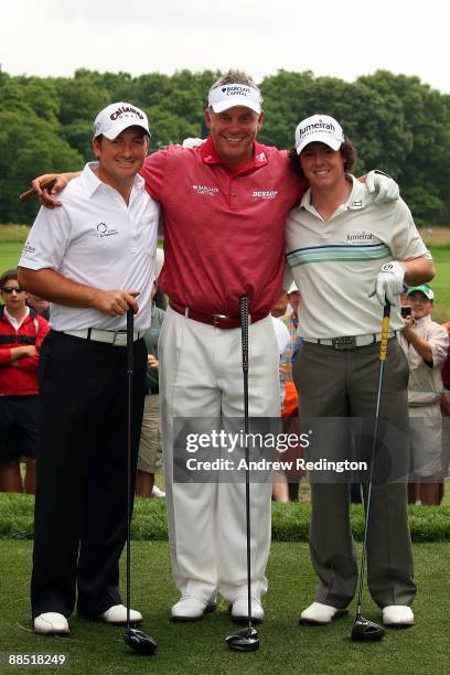 Graeme McDowell, Darren Clarke and Rory McIlroy of Northern Ireland pose together during the second day of previews to the 109th U.S. Open on the...