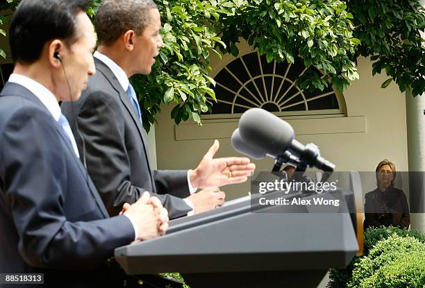 Secretary of State Hillary Rodham Clinton listens as President Barack Obama and South Korean President Lee Myung-Bak speak to the media during a...