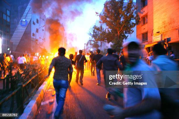 Supporters of defeated Iranian presidential candidate Mir Hossein Mousavi run in the streets during protests June 16, 2009 in Tehran, Iran. Iran...