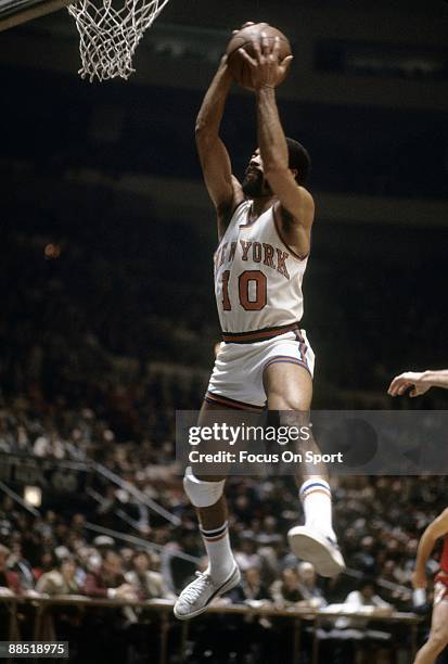 S: Walt Frazier of the New York Knicks in action pulls down a rebound against the Chicago Bulls during a early circa 1970's NBA basketball game at...