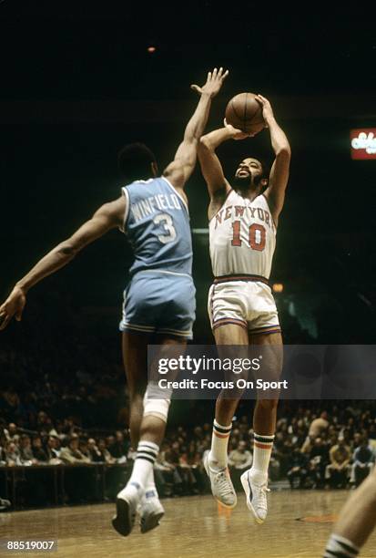 S: Walt Frazier of the New York Knicks shoots over Lee Winfield of the Buffalo Brave during a early circa 1970's NBA basketball game at Madison...