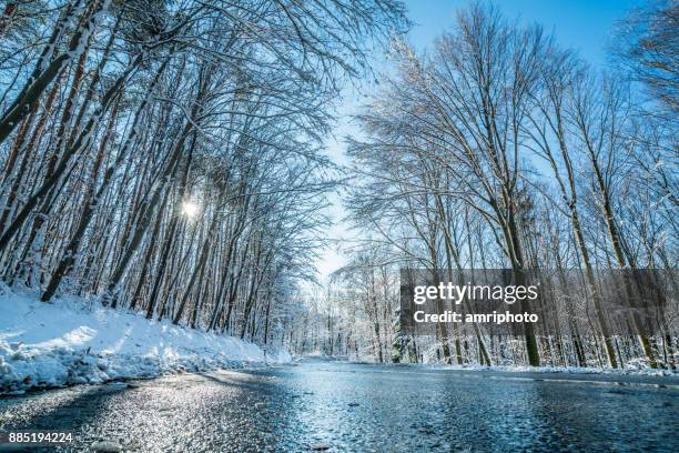 car trip - icy country road on cold sunny winter day - wet stock pictures, royalty-free photos & images