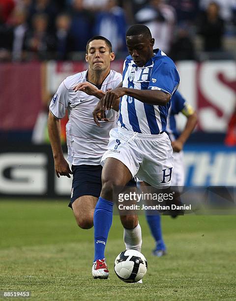 Maynor Figueroa of Honduras moves upfield with the ball as Clint Dempsey of the United States pursues during a FIFA 2010 World Cup Qualifying match...