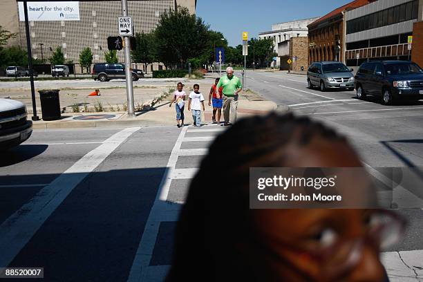 Shavonta Tripplett, age 10, waits for fellow homeless children at an intersection on June 15, 2009 in Dallas, Texas. More than 50 children currently...
