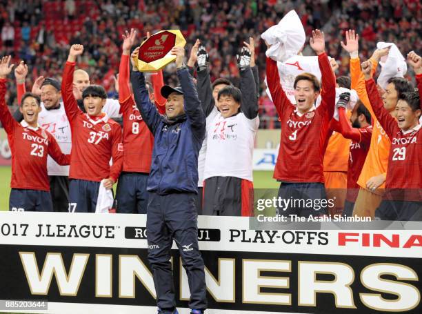 Head coach Yahiro Kazama of Nagoya Grampus lifts the trophy after the J.League J1 Promotion Play-Off Final between Nagoya Grampus and Avispa Fukuoka...