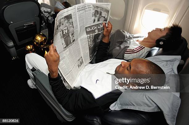 Kobe Bryant of the Los Angeles Lakers reads a newspaper on the team plane on June 15, 2009 after the Lakers defeated the Orlando Magic in the NBA...