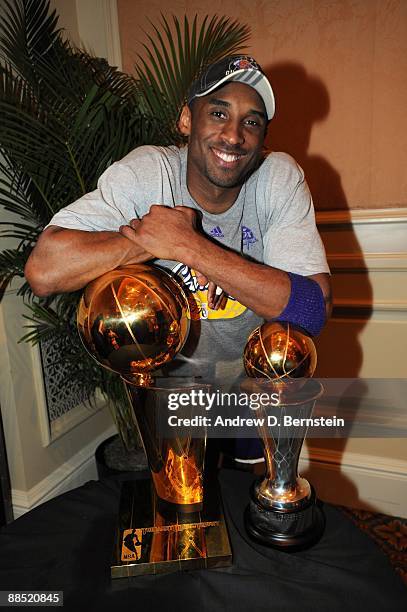 Kobe Bryant of the Los Angeles Lakers poses with the trophy after defeating the Orlando Magic in Game Five of the 2009 NBA Finals at post game party...