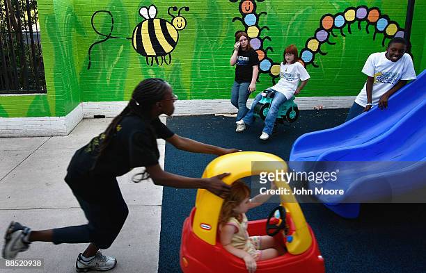 Shavonta Tripplett, age 10, pushes Hailey Morris, age 3, in a playground at the Family Gateway family homeless shelter on June 15, 2009 in Dallas,...