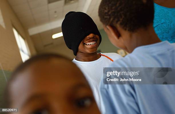 Homeless boy is blindfolded whhile being led by fellow children in a "trust walk" game at the Center of Hope shelter for homeless women and children...