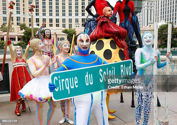 Cirque du Soleil performers, including Eli Skoczylas from the show "Mystere" wait outside the Bellagio for a Guinness World Record stilt walking...