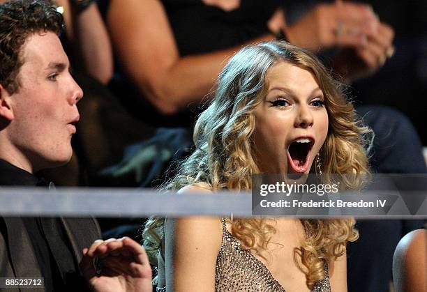 Singer Taylor Swift and Austin Swift react after winning an award during the 2009 CMT Music Awards at the Sommet Center on June 16, 2009 in...