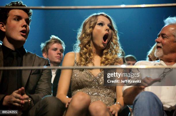 Singer Taylor Swift and Austin Swift react after winning an award during the 2009 CMT Music Awards at the Sommet Center on June 16, 2009 in...