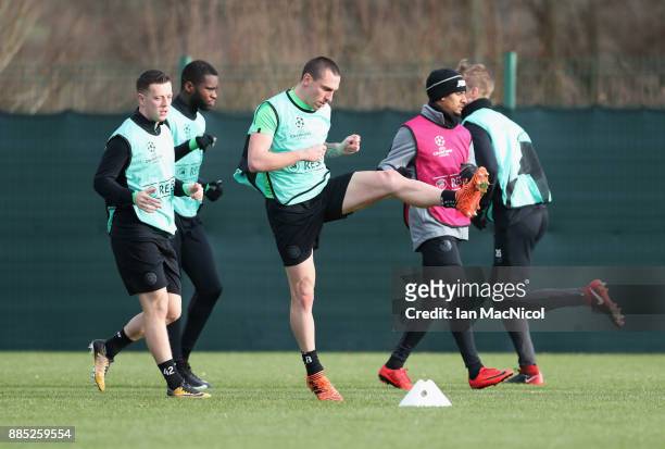 Scott Brown warms up with team mates during a Celtic training session on the eve of their UEFA Champions League match against Anderlecht at...