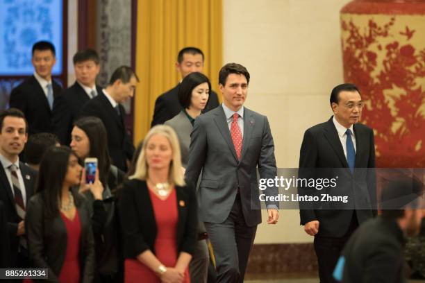 Chinese Premier Li Keqiang invites Canada's Prime Minister Justin Trudeau to view an honour guard during a welcoming ceremony inside the Great Hall...