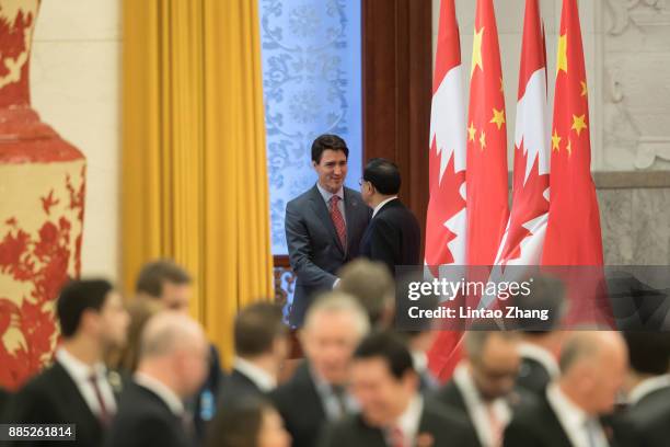 Chinese Premier Li Keqiang shakes hands with Canada's Prime Minister Justin Trudeau before during a welcoming ceremony inside the Great Hall of the...
