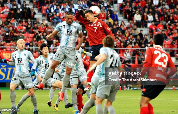 Taishi Taguchi of Nagoya Grampus and Wellington of Avispa Fukuoka compete for the ball during the J.League J1 Promotion Play-Off Final between Nagoya...