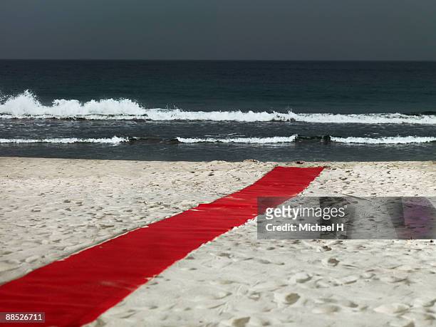 a red carpet on the beach - レッドカーペット ストックフォトと画像