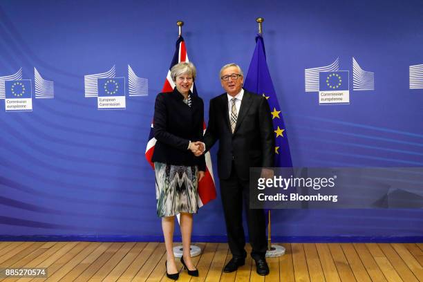 Theresa May, U.K. Prime minister, left, shakes hands with Jean-Claude Juncker, president of the European Commission, ahead of a meeting at the...