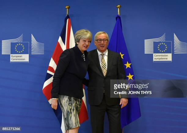 British Prime Minister Theresa May and European Commission chief Jean-Claude Juncker pose prior to a Brexit negotiation meeting on December 4, 2017...
