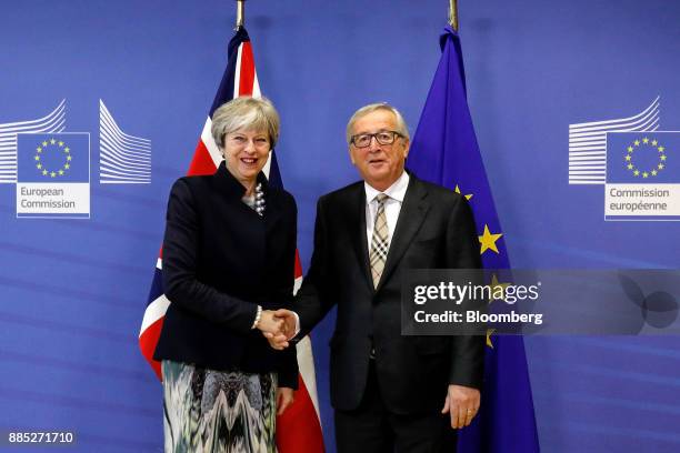 Theresa May, U.K. Prime minister, left, shakes hands with Jean-Claude Juncker, president of the European Commission, as they pose for photographs...