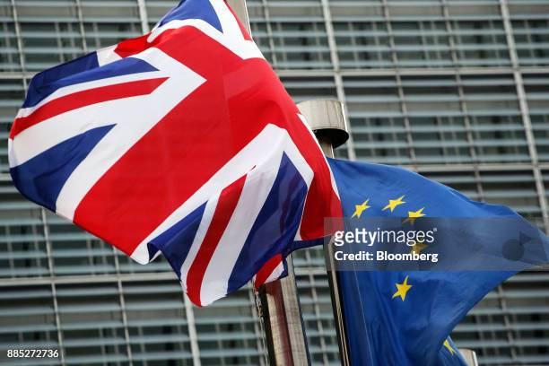 Union flag, also known as a Union Jack, left, flies next to a European Union flag outside the European Commission building in Brussels, Belgium, on...